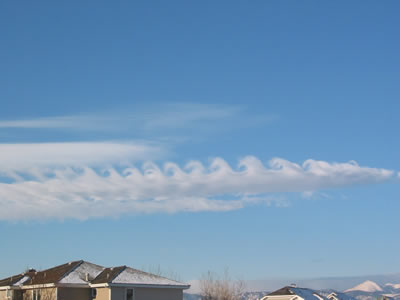 <a href="/earth/Atmosphere/clouds/kelvin_helmholtz.html&edu=elem">Kelvin-Helmholtz</a>
  clouds resemble breaking <a
  href="/earth/Water/ocean_waves.html&edu=elem">waves in
  the ocean</a>. They are usually the most developed near mountains or large
  hills. Wind deflected up and over a barrier, like a mountain, continues
  flowing through the air in a wavelike pattern. Complex <a
  href="/earth/Water/evaporation.html&edu=elem">evaporation</a>
  and <a href="/earth/Water/condensation.html&edu=elem">condensation</a>
  patterns create the capped tops and cloudless troughs of the waves. This
  image was taken on February 9, 2003 in the morning in Boulder, Colorado.<p><small><em>       Courtesy of Roberta Johnson</em></small></p>