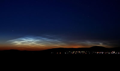 <a href="/earth/Atmosphere/NLC.html&edu=elem">Noctilucent</a>
  clouds are the highest clouds in the sky, but they are not associated with
  weather like the <a
  href="/earth/Atmosphere/clouds/cloud_types.html&edu=elem">other
  clouds</a> we regularly see in the sky. Noctilucent clouds form very high in
  the <a href="/earth/Atmosphere/overview.html&edu=elem">atmosphere</a>,
  in the <a
  href="/earth/Atmosphere/mesosphere.html&edu=elem">mesosphere</a>.
  They are best seen from Earth at sunset. This image was taken on June 15,
  2007, in Budapest, Hungary. Normally seen from locations near the <a
  href="/earth/polar/polar.html&edu=elem">poles</a> of
  the Earth, in recent years they have also been seen at much lower-latitude
  locations.<p><small><em> Image Courtesy of NASA/Veres Viktor</em></small></p>