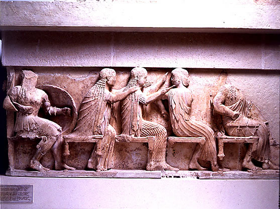 Left 
section of the east frieze of the Siphnian Treasury (c. 525 B.C.) depicting 
from left to right <a 
href="/mythology/Definitions_gods/Venus_def.html&dev=">
Venus</a>, <a 
href="/mythology/Diana_def.html&dev=">
Diana</a>, and <a 
href="/mythology/Definitions_gods/Apollo_def.html&dev=">
Apollo</a>. This portion of the frieze shows the gods sitting, watching the 
Greeks raid Troy.<p><small><em>   Image courtesy of the Superintendency (Ephoria) of Prehistoric and Classical Antiquities in Delphi. Greek Ministry of Culture-Archaeological Receipt Fund. (c) Greek Ministry of Culture.</em></small></p>